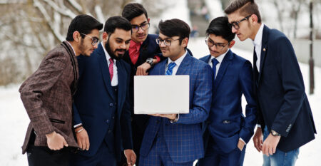 Group of six indian businessman in suits posed outdoor in winter Group of six indian businessman in suits posed outdoor in winter