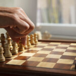 hand-playing-chess-classic-board